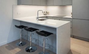 banqueta alta moderna giratoria com estofado cor preta em uma bancada americana magazine decor